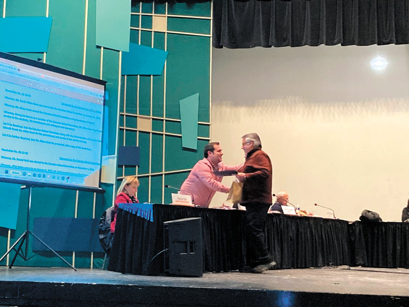 WELL DESERVED RECOGNITION: Domenic Fusco hands David Alden Sears a copy of his resolution and a gift bag for his time spent on the School Committee.